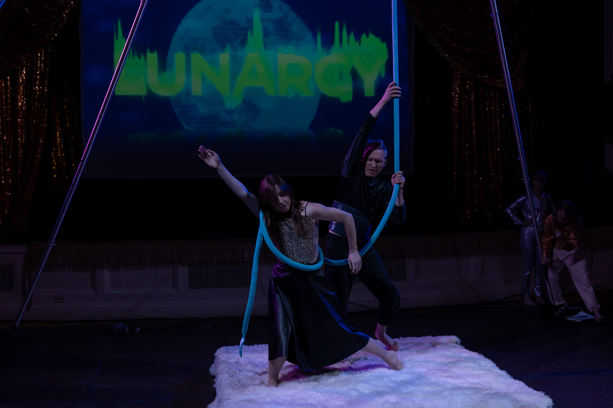Iomage of dancers in front of a screen that says LUNARCY.