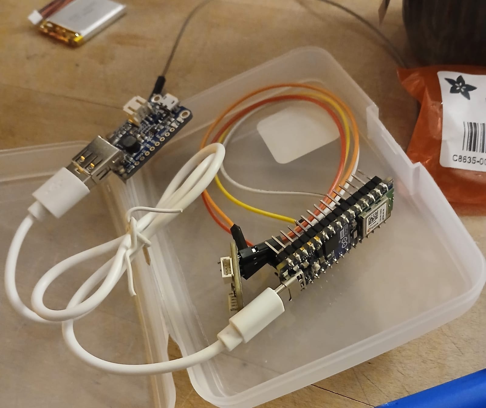 A photograph of an Arudino chip with cables connected to it. This chip is used to read data from sensors attached to the dancer's leg and send it over Wifi to a computer running Touchdesigner.