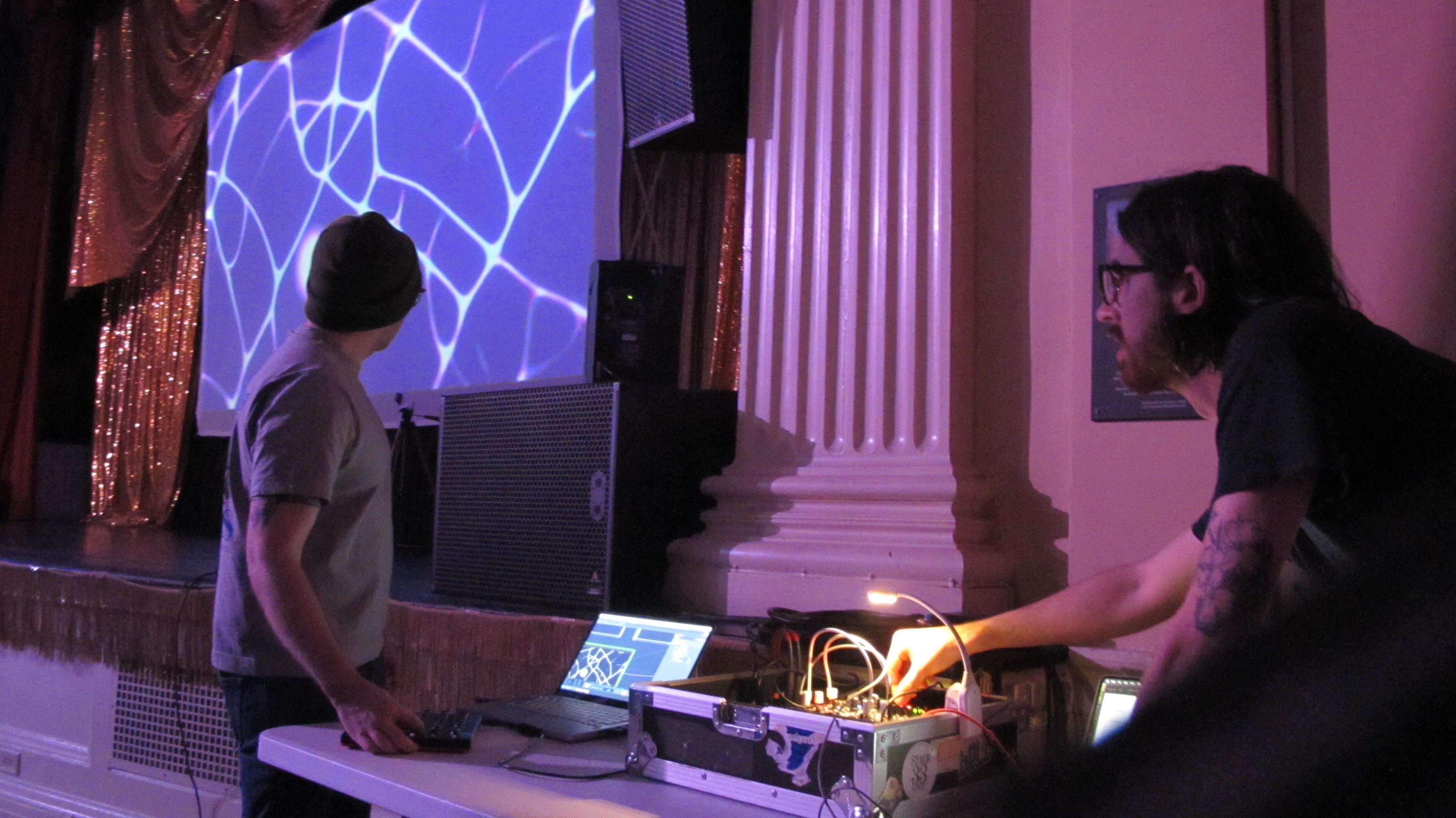 A photograph of Ben an Nate looking at a projetion screen.